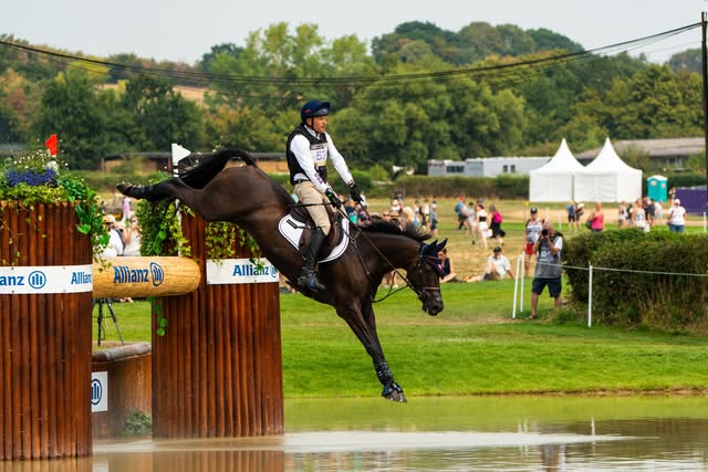 Horse and rider clearing a cross-country obstacle