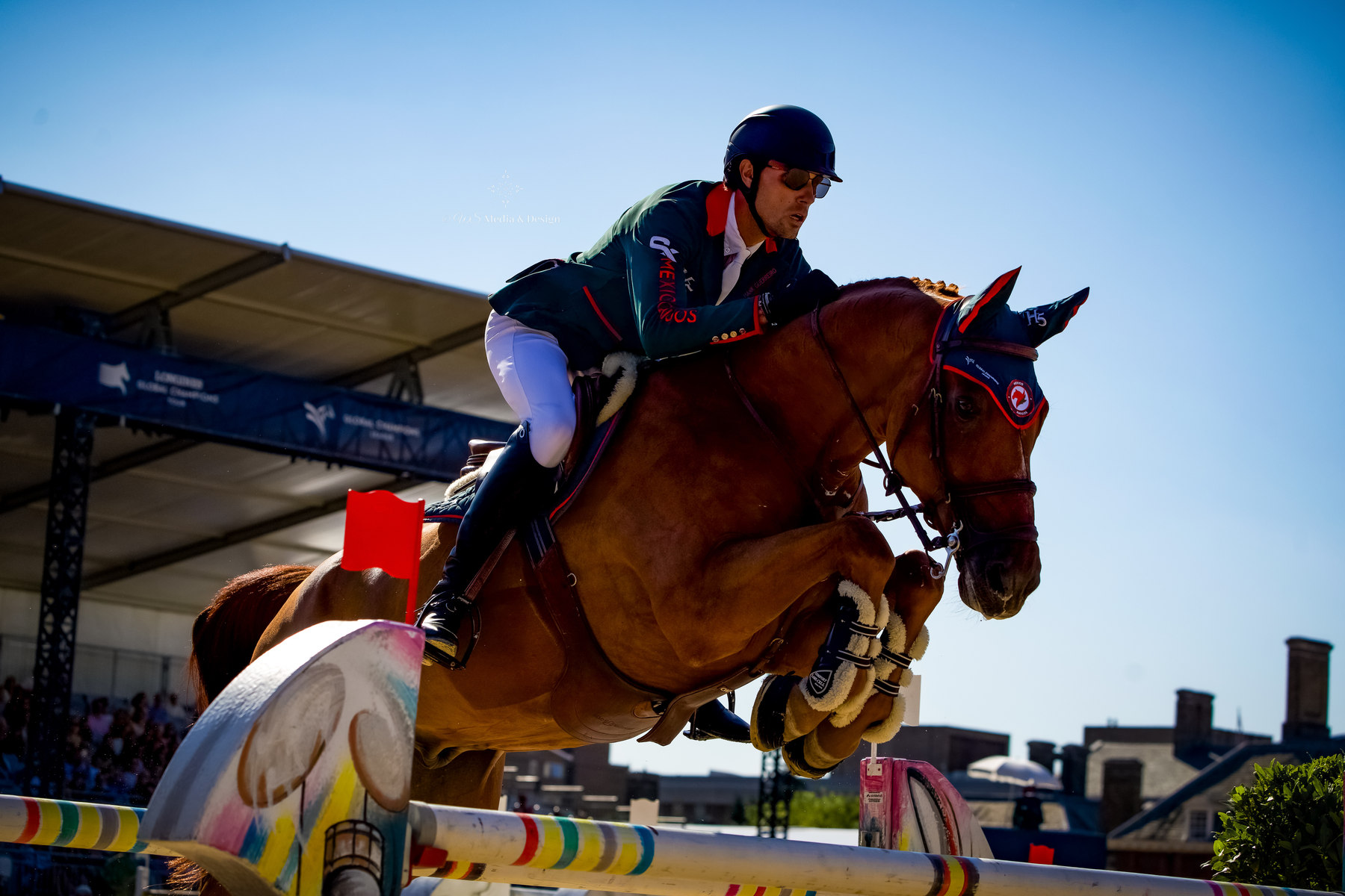 Horse and rider clearing a jump at LGCT London